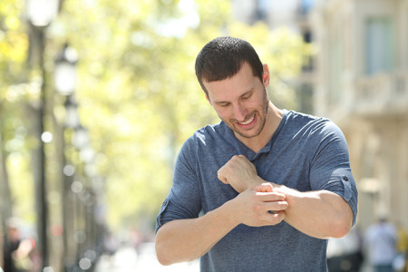 Man scratching his arm