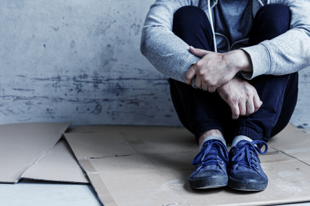 A young man sitting on the ground