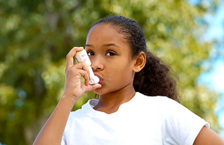 Girl with asthma inhaler