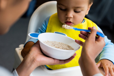 Mother feeding baby with a spoon