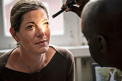 Woman getting eye exam for eczema