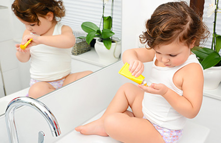 Child applying eczema-friendly lotion