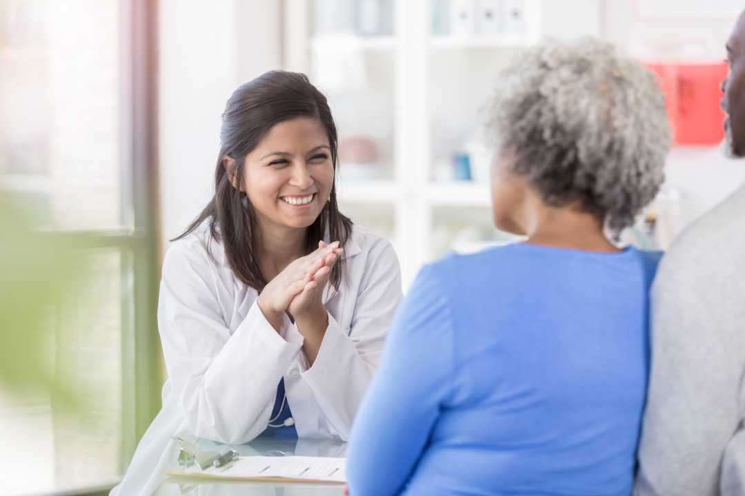 Dermatologist sharing skin care tips with Black patients