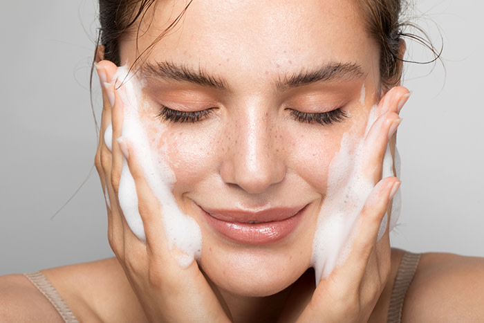 Woman washing her face