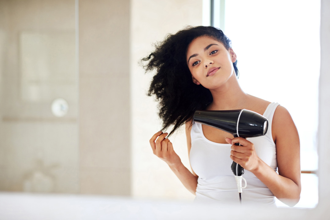 Woman with darker skin tone caring for her hair