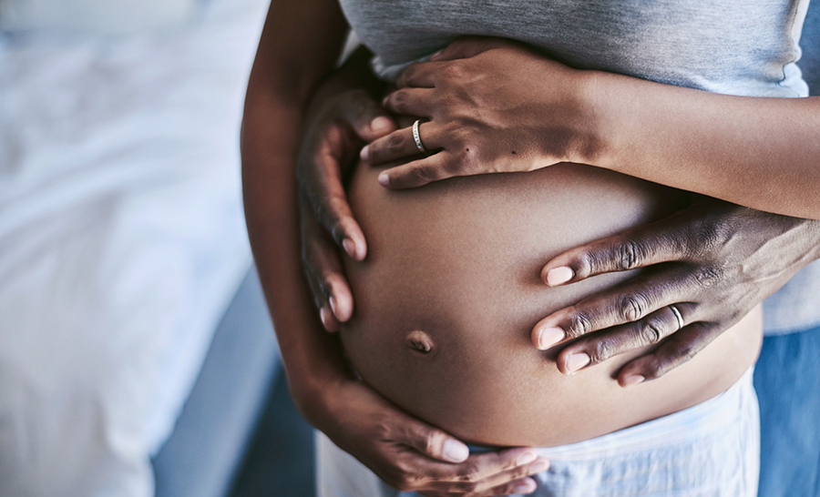 Pregnant abdomen with woman's and man's hands