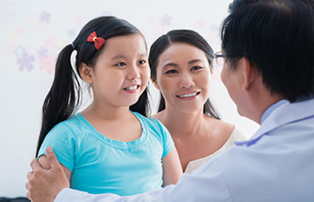 Girl with her dermatologist. Following a dermatologist’s treatment plan can help a child feel better.