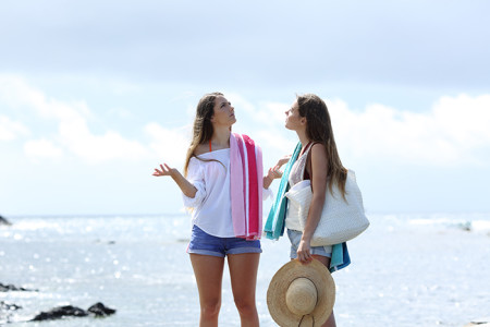 Two girls on a beach on a cloudy day