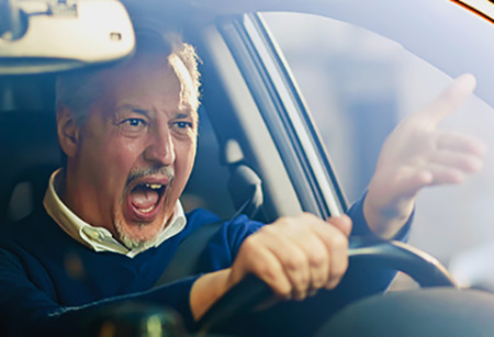 Angry male driver shouting in his car