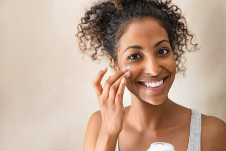 Woman applying face cream