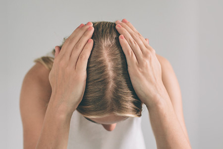 Woman showing the part in her hair