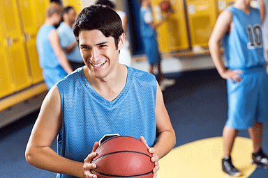 High school basketball players in locker room after game