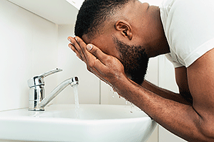 Man splashing water on his face