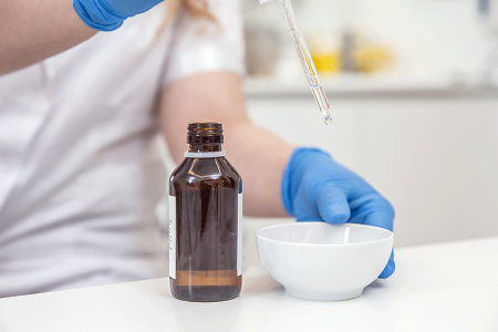 Dermatologist putting chemical peel ingredients with into bowl