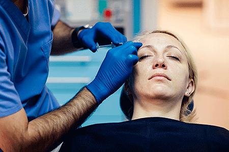 Dermatologist injecting patient with a cosmetic filler