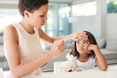 Mother taking sick child's temperature