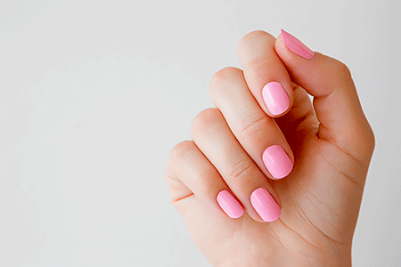 Woman's hand with pink nail polish