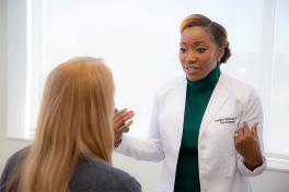 Female dermatologist with female patient