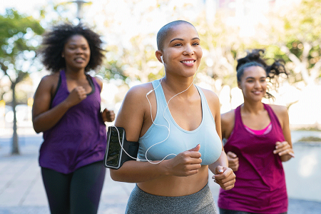 Three women with early signs of hair loss running outdoors.