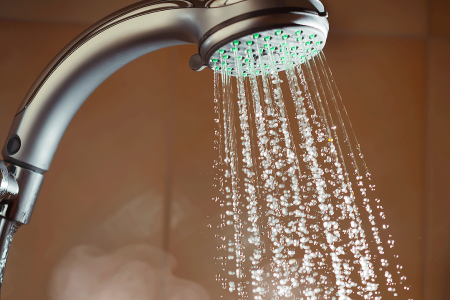 Shower with flowing water and steam, close-up view