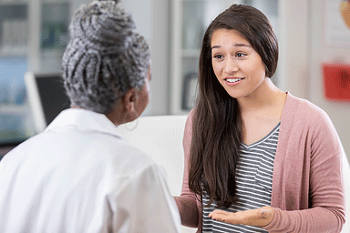 Patient asking dermatologist a question during office visit