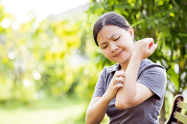 Woman scratching her arm