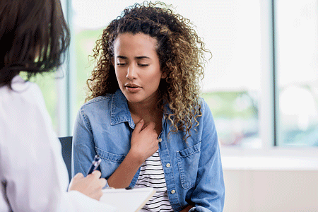 Young woman talks with dermatologist