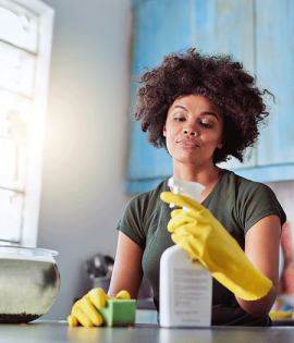 Woman disinfecting countertop