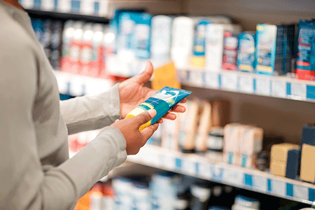 Man choosing sunscreen product in department store