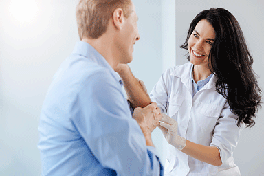 Young skillful dermatologist examining patient skin