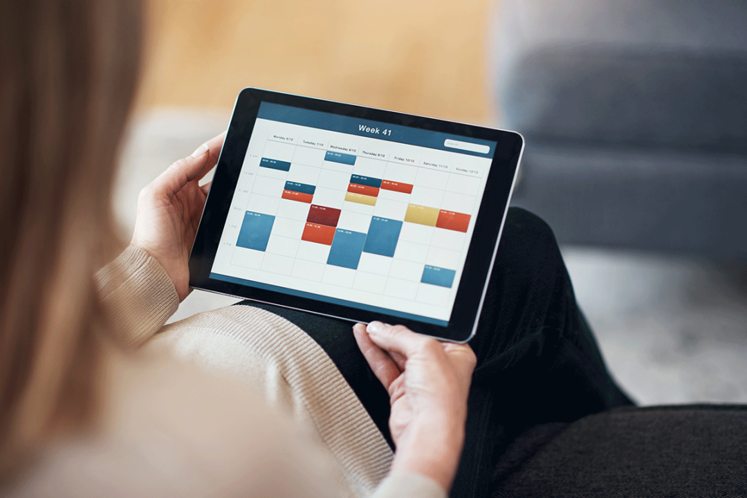 Woman looking at calendar meeting schedule on tablet