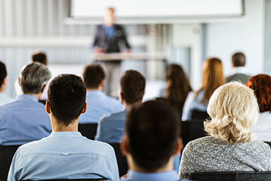 Rear view of business seminar in a board room.